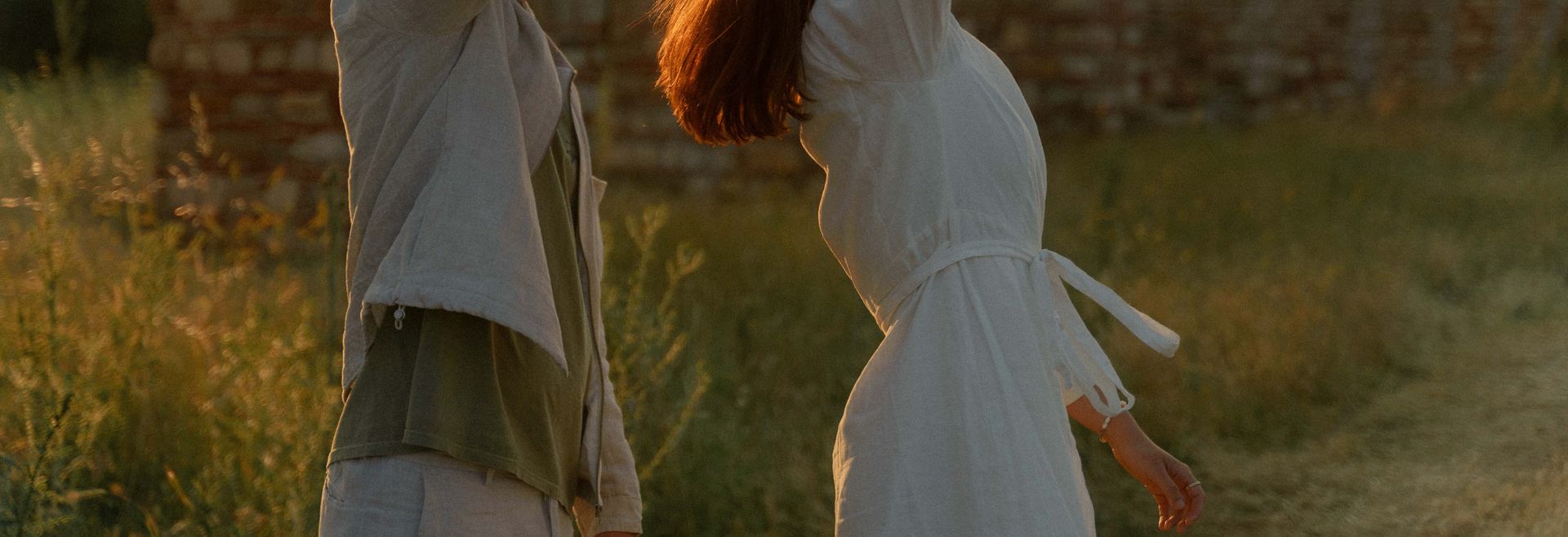 A man and a woman dancing at sunset with classy and light clothing
